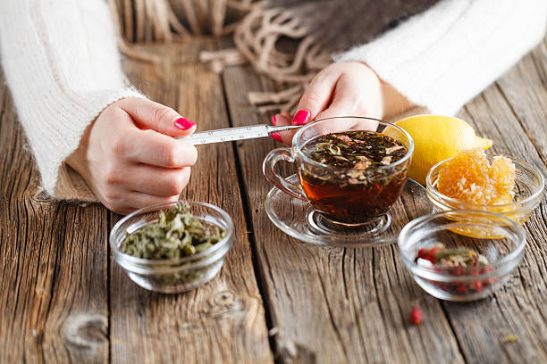 Thermometer measuring water temperature for herbal tea steeping